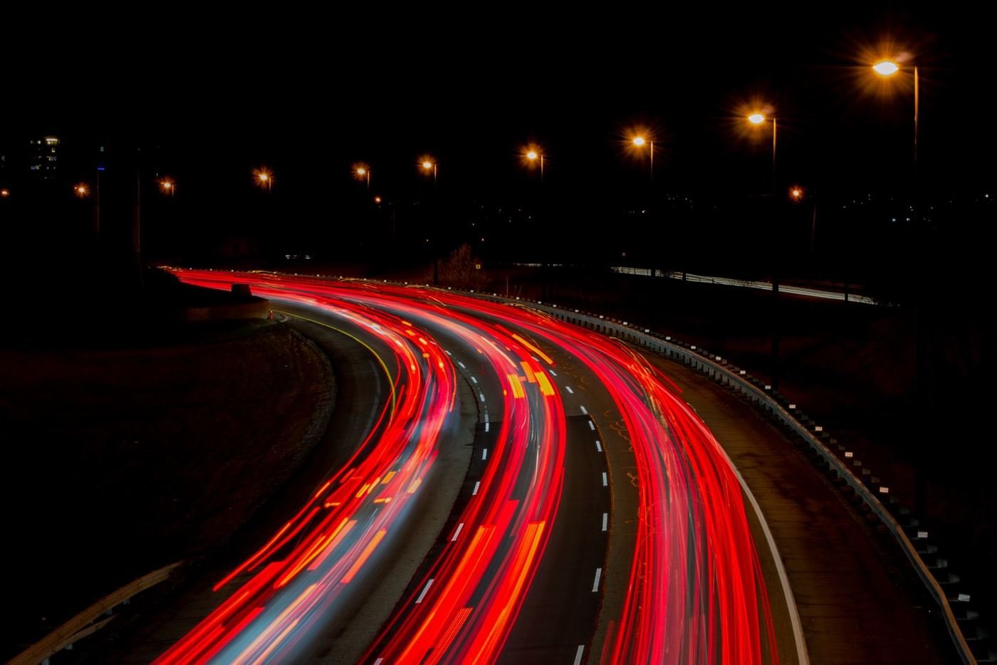 Traffic light trails sweeping along a motorway at night